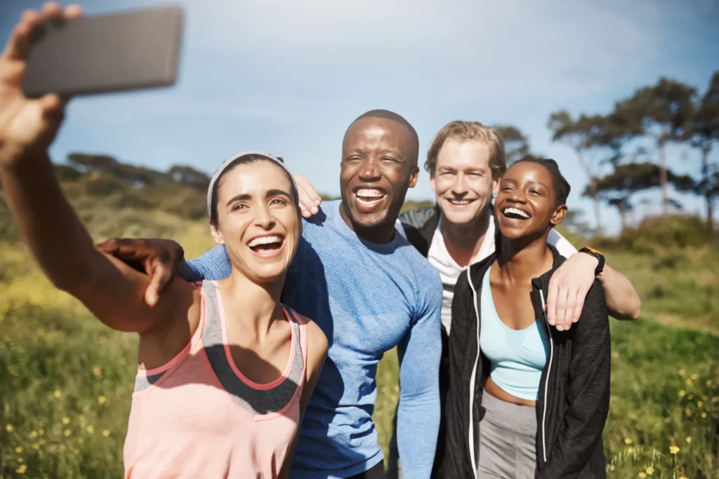 Energetic friends smiling after outdoor exercise, showing the joy of an active, pain-free life.