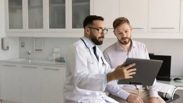 Doctor reviewing medical imaging results with a patient during a consultation.